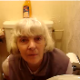 Someone video-records her British grandmother in the bathroom. She appears to be wiping her ass.